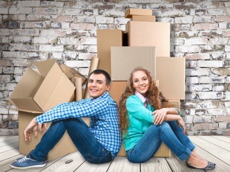 Professional movers loading household items into a removal van