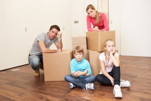 Local moving team handling furniture in a Lower Clapton street