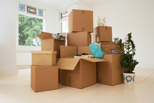 Removal team handling furniture and boxes for a home move in Lower Clapton